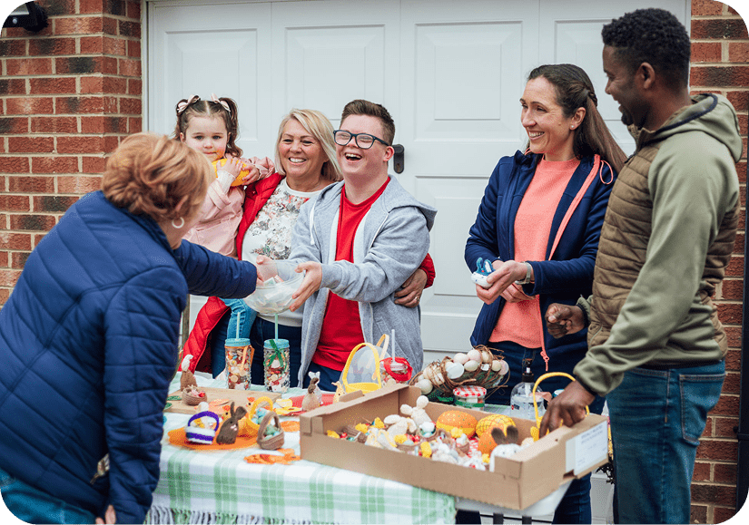 Group smiling at outdoor sale