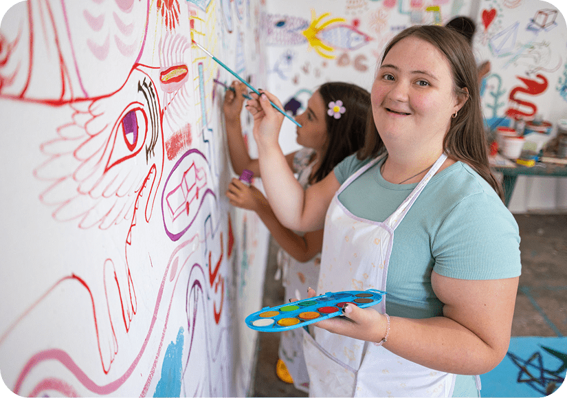 Smiling girl holding paint palette