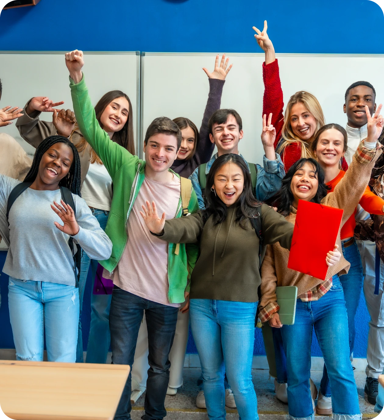 Diverse students posing in a classroom